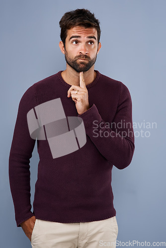 Image of Thinking, wonder and man in studio with unsure, uncertain and thoughtful on gray background in studio. Doubt mindset, mockup space and face of male person thoughtful for decision, choice and question