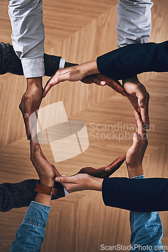 Image of Synergy, motivation or hands of business people in circle for sustainability, support or recycling in above office. Teamwork, recycle or employees for sustainable, community help or partnership group