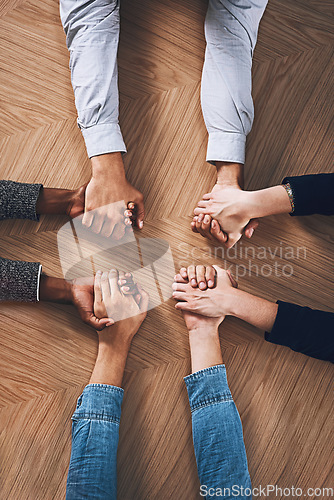 Image of Above, diversity or business people holding hands for support, team building or teamwork in office. Partnership, zoom or employees in group collaboration with solidarity or mission for goals together