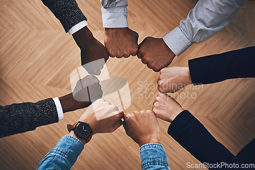 Image of Teamwork, fist bump or hands of business people for motivation, group support or community in office. Team building, above or circle of fists for diversity, collaboration or partnership mission