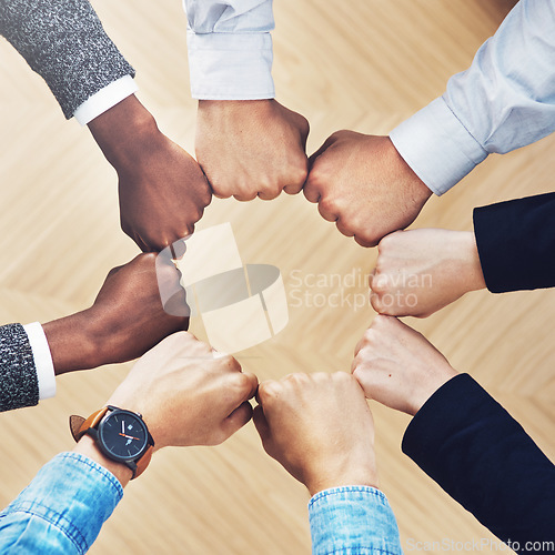 Image of Team building, fist bump or hands of business people for diversity, group support or community in office. Teamwork, above or circle of fists for motivation, collaboration or partnership for a mission