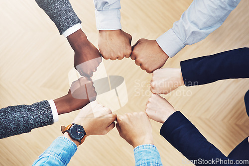 Image of Teamwork, fist bump or hands of business people together for motivation, group support or community. Collaboration, team building or above of circle fists for diversity, trust or office partnership