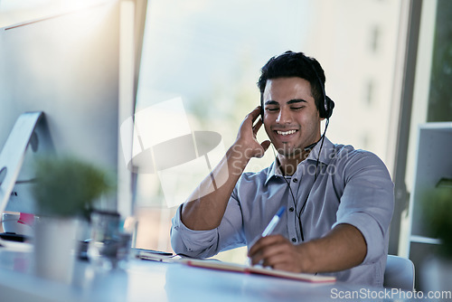 Image of Customer support agent, smile and notes, man consulting with advice, sales information and help desk. Phone call, conversation and callcenter consultant writing in notebook while speaking in office.