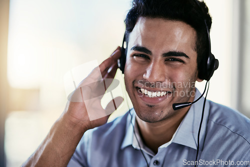 Image of Customer service agent, smile and portrait of happy man consulting with advice, help and happiness at desk. Phone call, conversation and callcenter consultant speaking into headset in modern office.