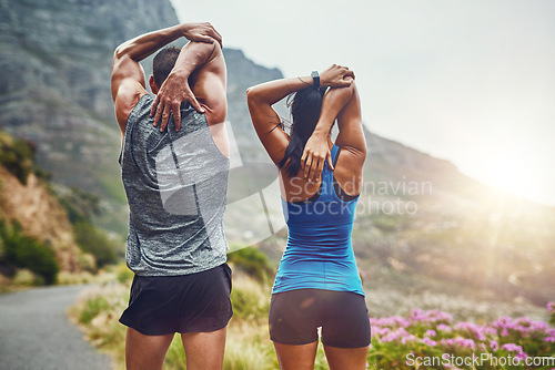 Image of Back, fitness and stretching with a sports couple outdoor in nature for a cardio or endurance workout. Exercise, warm up or getting ready with a man and woman athlete training together in nature