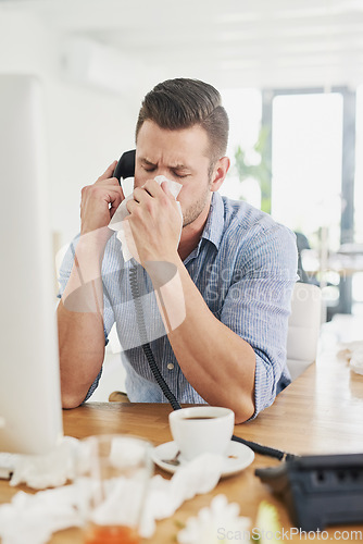 Image of Business man, blowing nose and phone call with allergy, virus and tissues for healthcare at desk. Sick young businessman, allergies or tired of hayfever, toilet paper and cleaning mucus in workplace