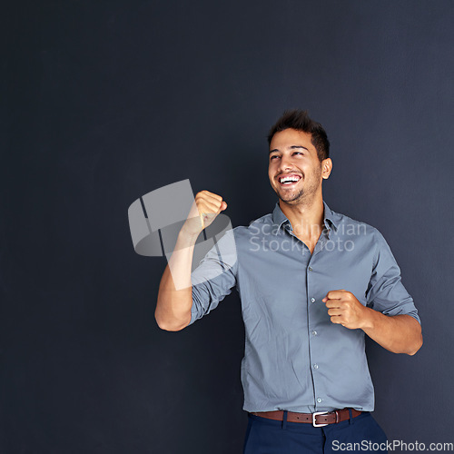 Image of Mockup, happy man and winning fist in studio for success, victory or small business loan approval. Yes, hand and excited male entrepreneur celebrating good news or career milestone on grey background