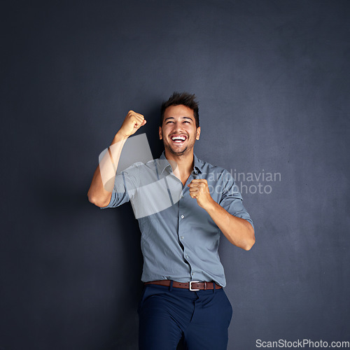 Image of Portrait, happy man and winning fist in studio for success, victory or small business loan approval. Face, hand and male entrepreneur celebrating good news or career milestone on black background