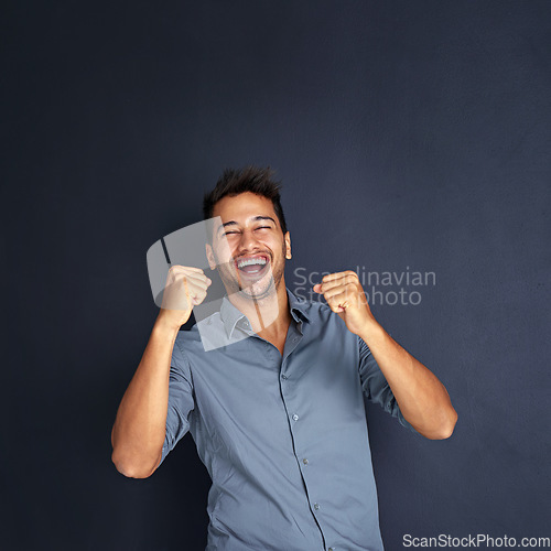 Image of Portrait, winning and man with fist in studio for success, victory or small business loan approval. Face, hand and male entrepreneur celebrating good news or career milestone on black background