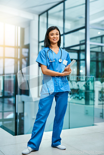 Image of Nurse woman, portrait and smile with tablet for service, healthcare and happy for job in hospital. Asian female medic, happiness and tech for medical career, helping and pride for working in clinic