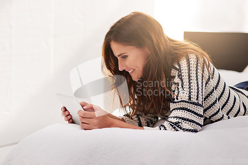 Image of Smile, search and tablet with woman on bed for social media, communication and digital. Internet, technology and website with female person reading online at home for ebook, streaming and happiness