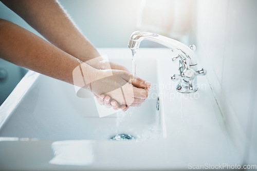 Image of Hands, water and washing for clean and safe skin for wellness in the bathroom at home. Wash hand, woman and liquid for skincare, bacteria, cleaning and disinfection for germs with safety at house.