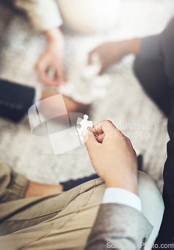 Image of Businessman, hands and puzzle piece in team building, meeting or problem solving together at office. Hand of man person in teamwork, jigsaw activity or collaboration for project together at workplace