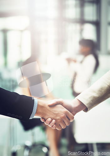Image of Partnership, handshake and business people in office for a deal, collaboration or corporate meeting. Teamwork, introduction and closeup of employees shaking hands for greeting or welcome in workplace