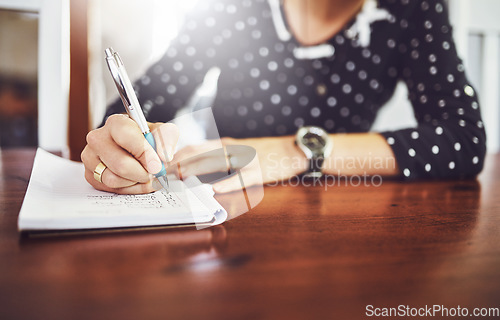 Image of Woman, writing and home table with notebook and day schedule in a dinning room. Lens flare, female person and to do list in a house with notepad, page and book for planning to write a article