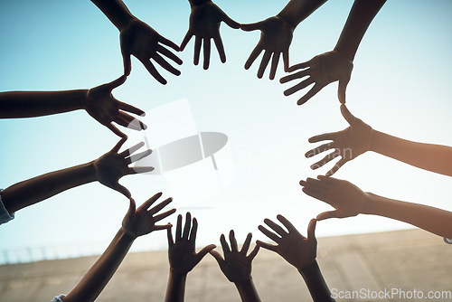 Image of Teamwork, circle and blue sky with hands of people for support, community and help with bottom view. Collaboration, trust and motivation with closeup of friends for partnership, solidarity and faith