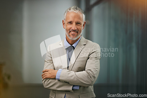 Image of Portrait, confident and arms crossed with a business man in his office, looking happy about his company growth. Mission, mindset and vision with a senior male corporate manager standing at work