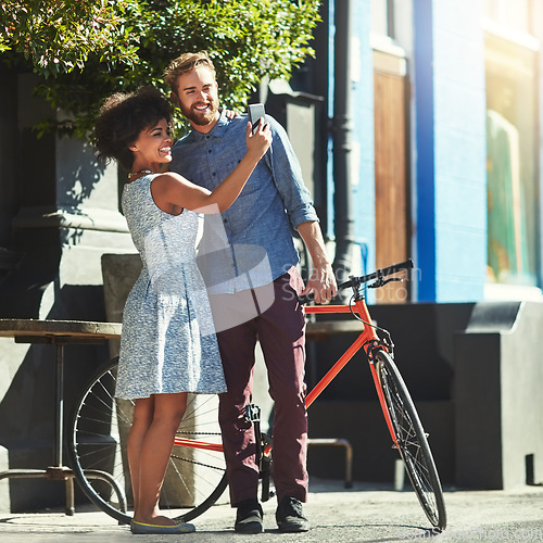 Image of Happiness, selfie and diversity couple of city friends with outdoor picture memory of date, romance or morning bike commute. Bicycle, urban bonding and marriage people post photo to social media app