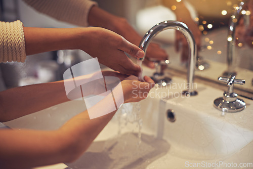 Image of Water, closeup and washing hands by mother and child in a bathroom for learning, hygiene and care. Basin, home and hand cleaning by mom and girl together for prevention of bacteria, dirt and germs