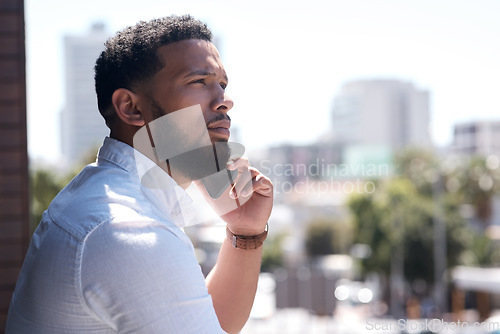 Image of Serious, black businessman and call on a cellphone in a city or standing outside talking or office overlooking on bokeh. Communication, face and corporate professional on mobile or conversation