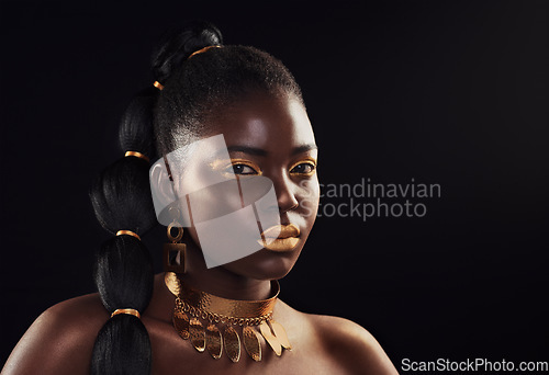 Image of Beauty, portrait and black woman in studio with glitter, luxury and art makeup on dark background. Face, gold and African lady model with rich, glow and jewelry, elegance and cosmetic royal aesthetic