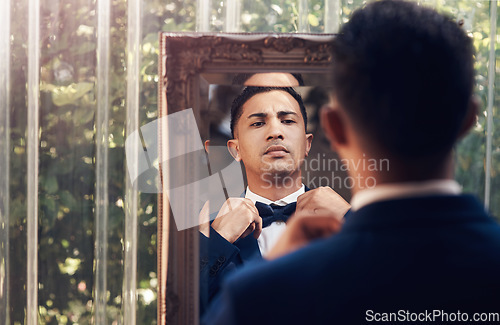 Image of Mirror, wedding and man with a bow tie, marriage and prepare for ceremony, love and celebration. Male person, gentleman and groom with a suit, fashion and ready for event with romance and reflection