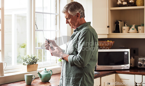 Image of CBD oil, tea and a senior man in the kitchen of a retirement home for his morning medication routine. Thinking, medical cannabis and dose with a mature man holding a medicine bottle in his house