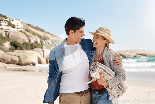 Image of Love, happy couple at the beach and walking together hugging on seashore, Summer vacation or holiday break, adventure or traveling journey and young people walk at sea for fresh air with blue sky