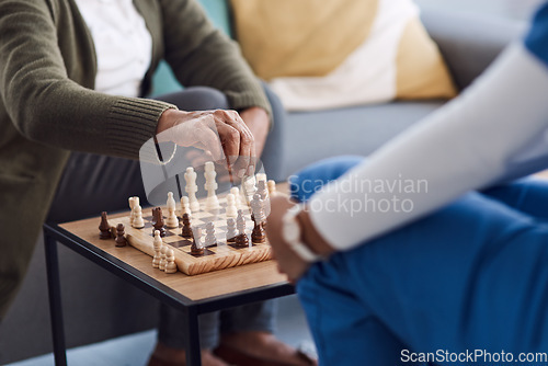 Image of Hands, chess a nurse with a patient in a nursing home playing a game of strategy during a visit. Healthcare, medical or insurance with a medicine professional and resident in the living room together