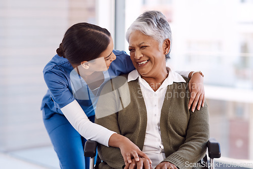 Image of Healthcare, disability and a nurse hugging an old woman in a wheelchair during a nursing home visit. Medical, hug and funny with a laughing female medicine professional talking to a senior resident