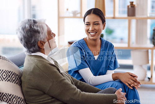 Image of Healthcare, happy and a nurse talking to an old woman in a nursing home during a visit or checkup. Medical, smile and a female medicine professional having a conversation with a senior resident