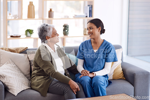 Image of Healthcare, retirement and a nurse talking to an old woman on a sofa in the living room of a nursing home. Medical, trust and care with a female medicine professional chatting to a senior resident