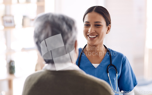 Image of Healthcare, happy and a nurse talking to an old woman about treatment in a nursing home facility. Medical, smile and a female medicine professional chatting to a senior resident during a visit