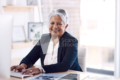 Image of Portrait, computer and management with a business woman or CEO working in her corporate office. Vision, professional and leadership with a senior female manager at work typing an email or proposal