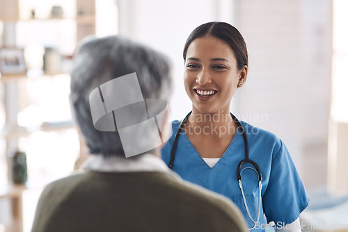 Image of Healthcare, smile and a nurse talking to an old woman about treatment in a nursing home facility. Medical, happy and a female medicine professional chatting to a senior resident during a visit