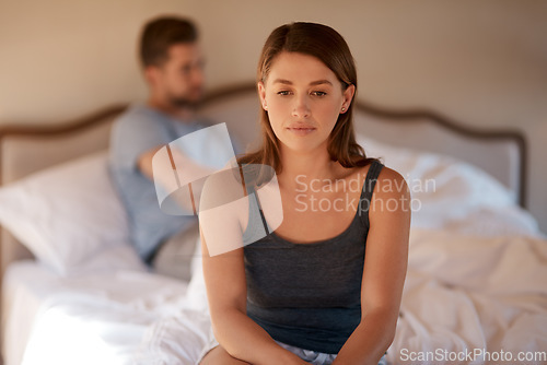 Image of Sad, upset and couple in an argument in their bedroom for divorce or breakup in a modern house. Toxic, mad and face of a woman fighting and in conflict with her boyfriend in bed in their home.