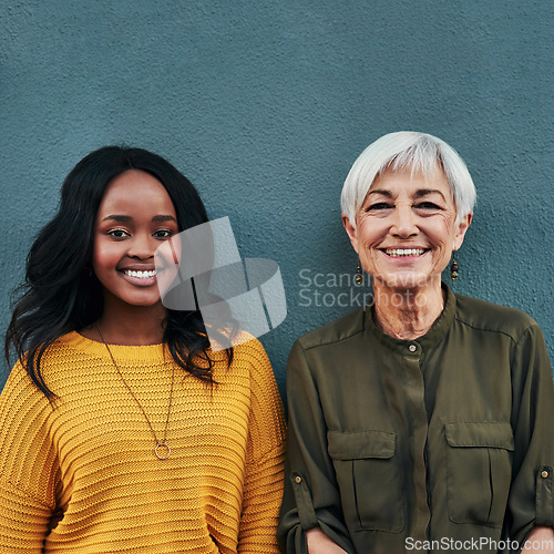 Image of Together, diversity and portrait of women on a blue background for success, happiness and work. Smile, business and a young and senior employee standing on a wall for a professional career profile