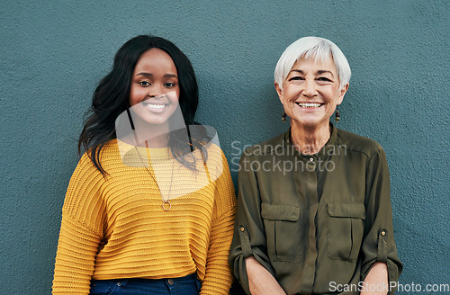 Image of Happy, diversity and portrait of women on a blue background for success, happiness and work. Smile, business and a young and senior employee standing on a wall for a professional career break