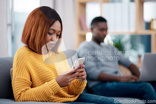 Image of Relax, phone or technology addiction and a woman on a sofa in the living room of her home with her boyfriend on a blurred background. Mobile, contact and social media with a female person in a house