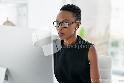 Image of Business, computer and serious black woman in office for research, planning or concentration. Focus, mindset and African female copywriter online for creative idea inspiration on blurred background