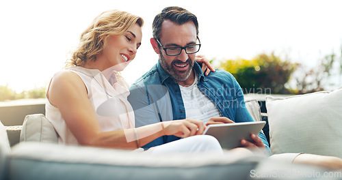 Image of Couple, sofa and tablet for online shopping, streaming or reading, social media communication or ecommerce. Woman, man and relax together on holiday with technology, movie service or network