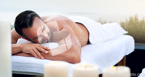 Image of Man, spa and relax on massage table outdoor at holiday resort, vacation and peace at hotel. Mature male person resting on beauty salon bed for body cosmetics, luxury service and calm muscle therapy