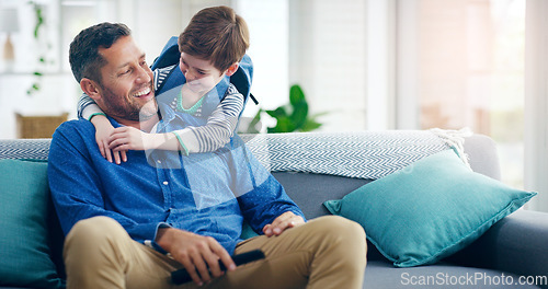 Image of Dad, child and hug in a family home with love and care on living room sofa with a smile after school. A man or dad with a kid or son together on a couch for quality time, bonding and fathers day