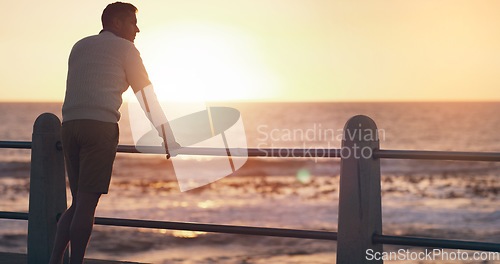 Image of Back view, sunset and thinking man by beach on vacation or holiday mockup space. Ocean, idea and male person relax outdoor by sea for travel, freedom and enjoying summer peace alone at promenade.