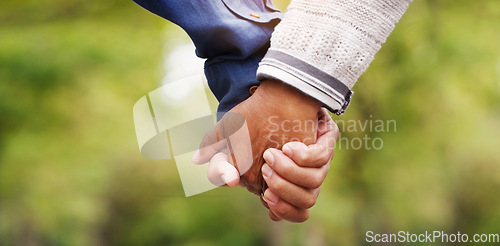 Image of Closeup, love and couple holding hands, outdoor and relationship with romance, bonding and support. Zoom, partners and man with woman, touching hand and trust with solidarity, marriage and nature