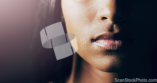 Image of Sensual, beauty and closeup of woman lips for cosmetic, makeup and natural routine in a studio. Beautiful, cosmetics and zoom of a female model mouth with lipgloss for self care by a black background