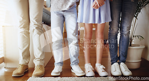 Image of Love, family and closeup of people with shoes standing in a line in the living room of their home. Bonding, together and zoom of couple and children legs in a row in the lounge of their modern house.