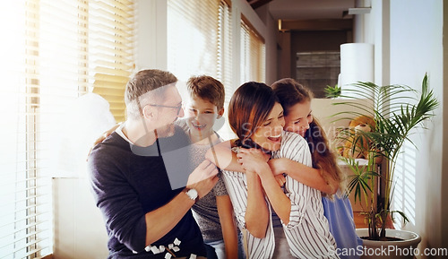 Image of Happy, love and family in their new home, moving and loving with embrace, laughing and cheerful together. Parents, mother and father with kids, children and siblings in an apartment and milestone