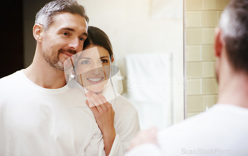 Image of Home, love and couple in a bathroom, mirror and cleaning with hygiene, hug and loving together. Partners, man and woman with a smile, reflection and fresh with skincare, grooming and morning routine