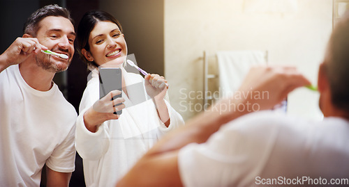 Image of Selfie, brushing teeth and couple in a bathroom, mirror and happiness with hygiene, home and wellness. Partners, man or woman with a smile, social media or mouth cleaning with reflection or self care